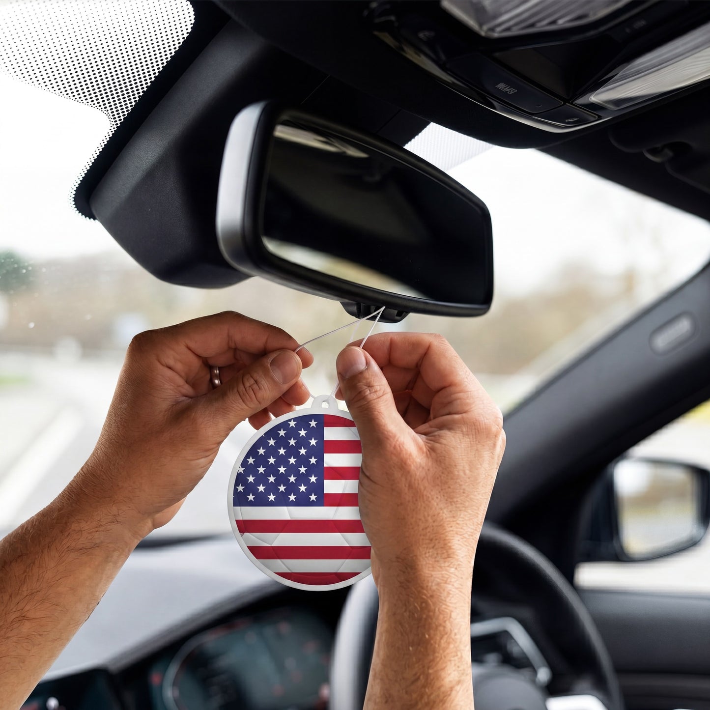 USA flag car freshener hanging on rearview mirror