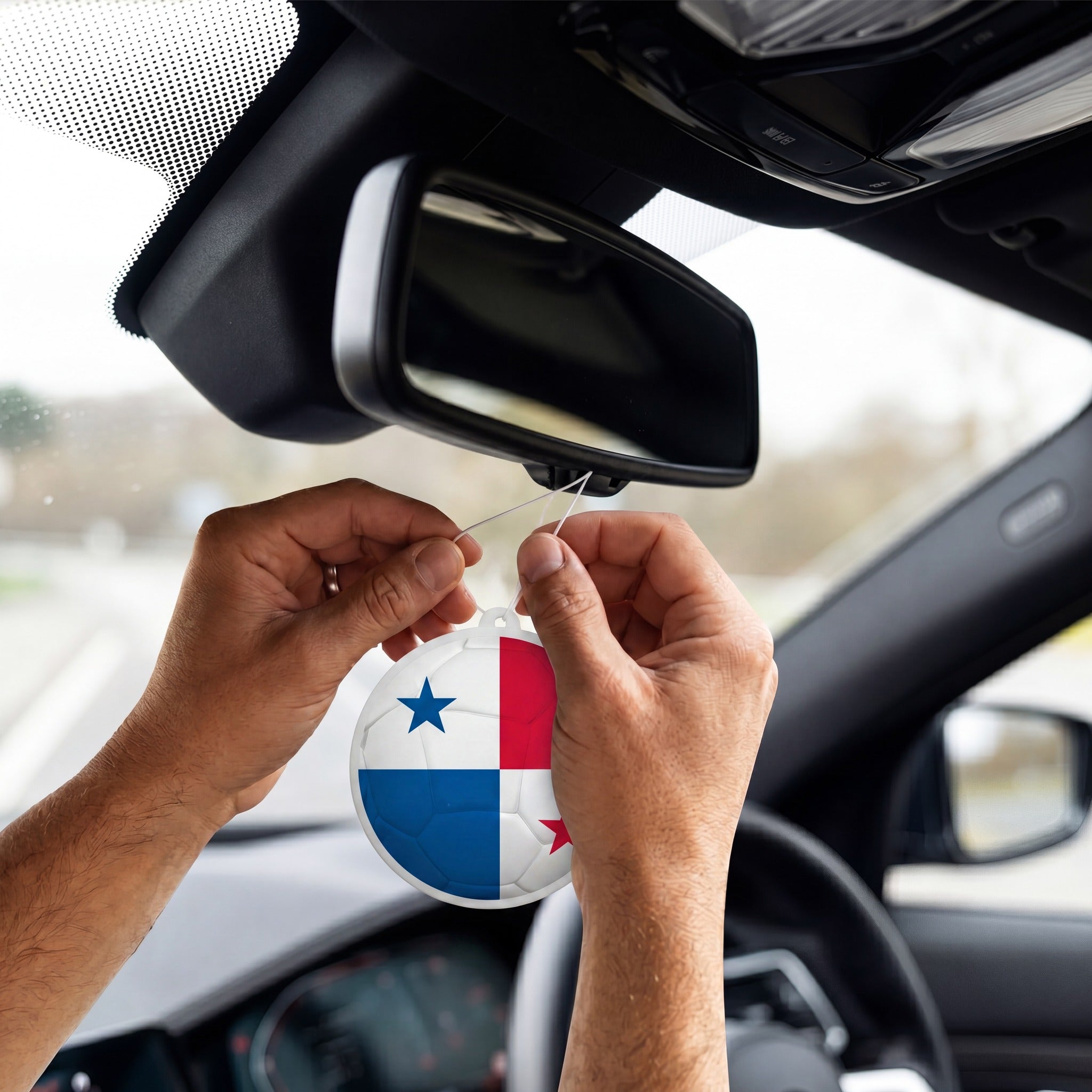 Panama flag car freshener hanging on rearview mirror